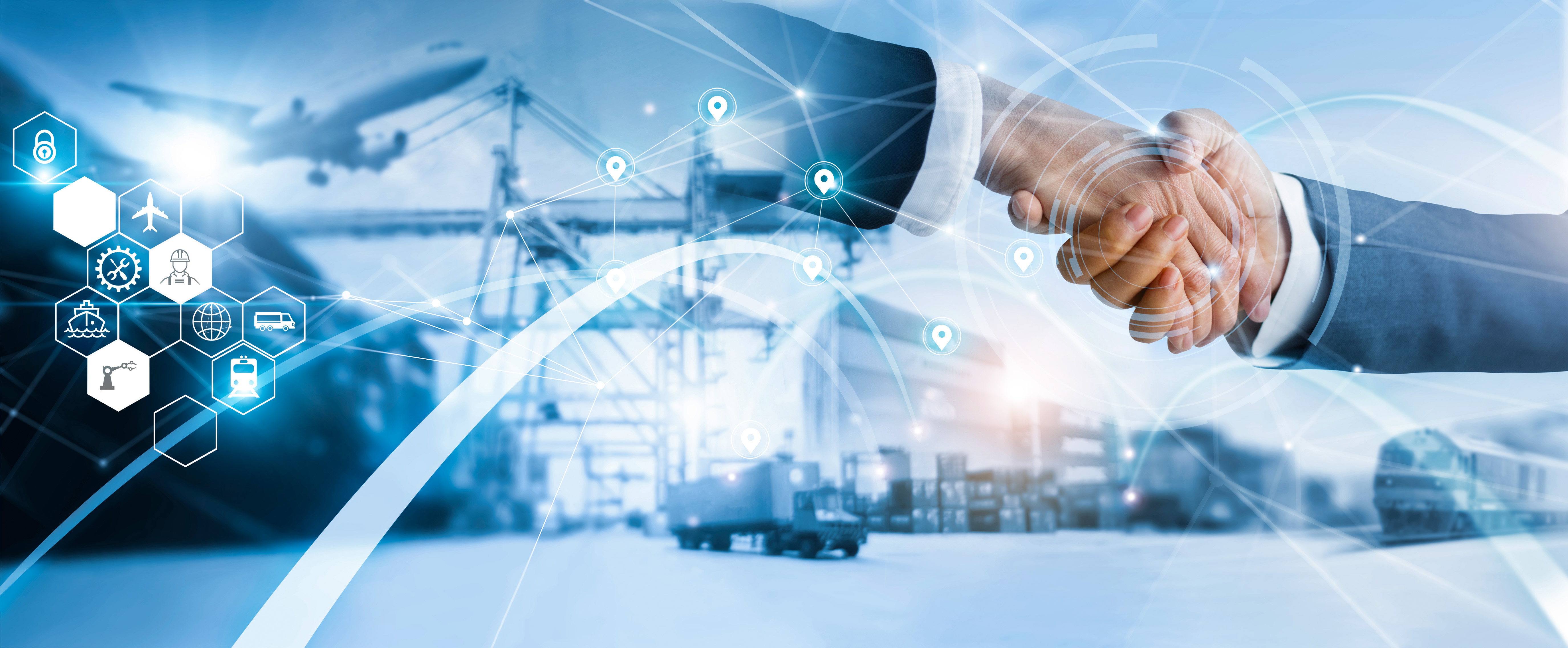 Handshake over a logistics yard, representing Southwest Distributors as a supply partner