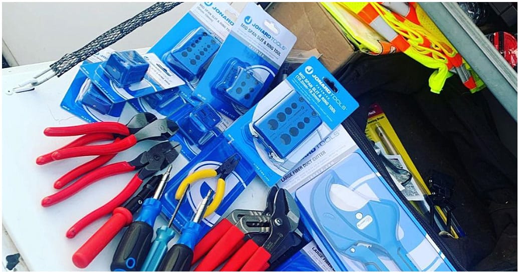 Jonard hand tools, cutters and cable tools laid out in a service van bin